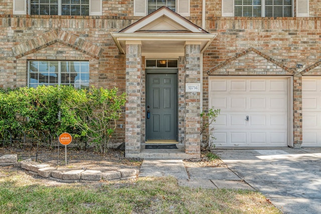 view of exterior entry featuring a garage