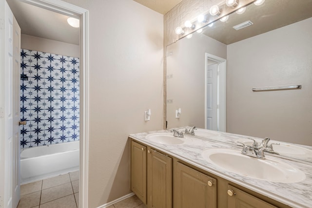 bathroom with vanity, a bathtub, and tile patterned flooring