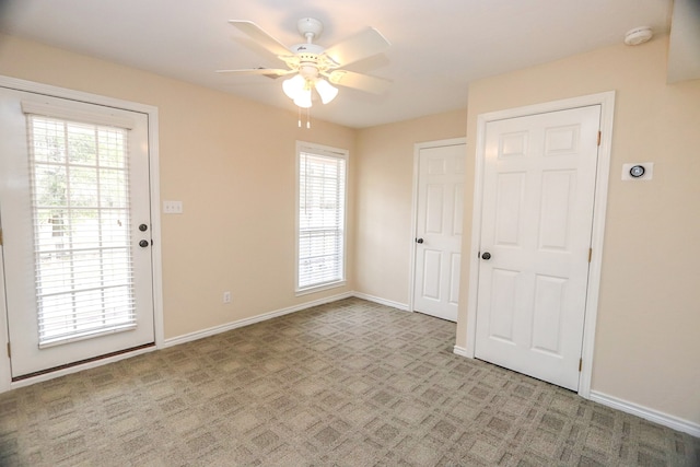 spare room with light carpet and ceiling fan