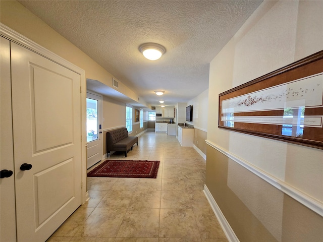 hall with light tile patterned flooring