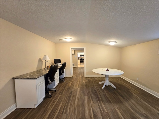 office with dark hardwood / wood-style floors and a textured ceiling