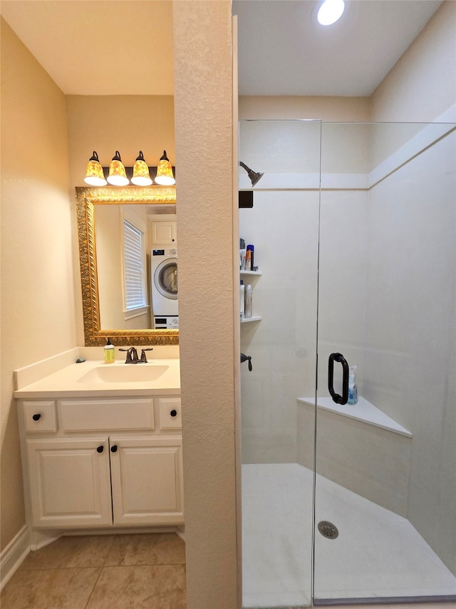 bathroom with tile patterned floors, a shower with door, and vanity