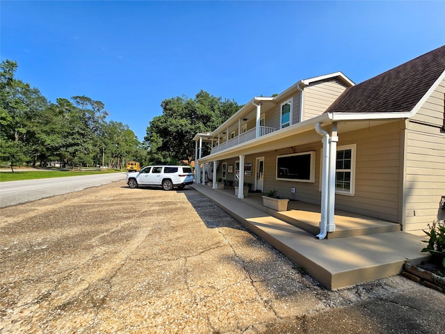 exterior space featuring a balcony and covered porch