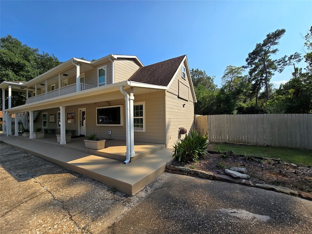 back of property featuring a balcony