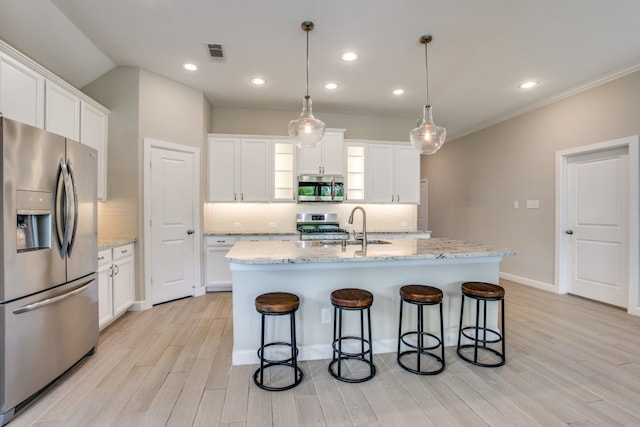 kitchen with appliances with stainless steel finishes, white cabinetry, and backsplash