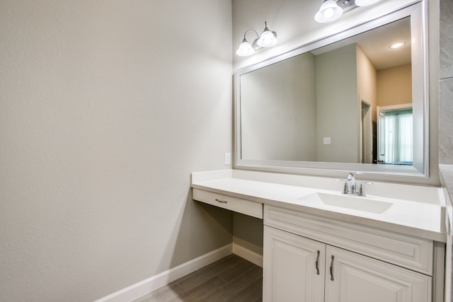 bathroom with vanity and hardwood / wood-style flooring