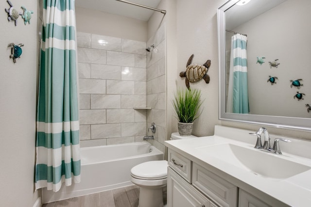 full bathroom featuring shower / bath combo, hardwood / wood-style floors, vanity, and toilet