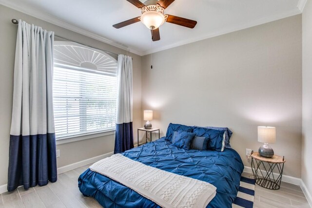 bedroom featuring ceiling fan, light wood-type flooring, and ornamental molding