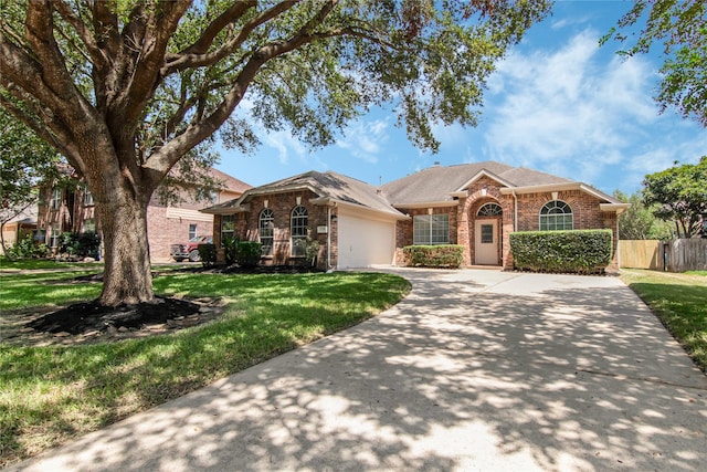 ranch-style house featuring a front yard and a garage