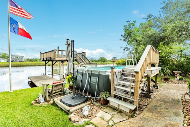 exterior space with a swimming pool side deck with water view