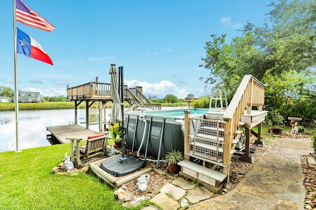 131 Bastrop Bayou Dr, Angleton, TX 77515 - dock area featuring a lawn, an outdoor pool, and a deck with water view