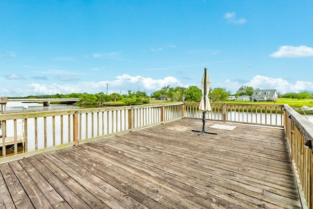 wooden deck featuring a water view