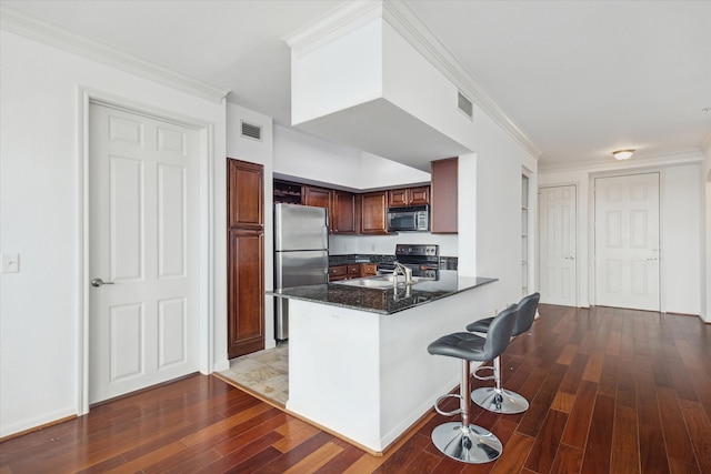 kitchen featuring kitchen peninsula, stainless steel fridge, dark hardwood / wood-style floors, and black electric range