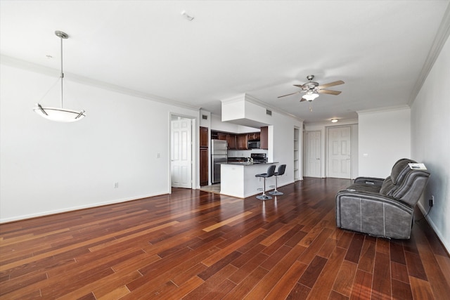 living room with crown molding, dark hardwood / wood-style flooring, and ceiling fan