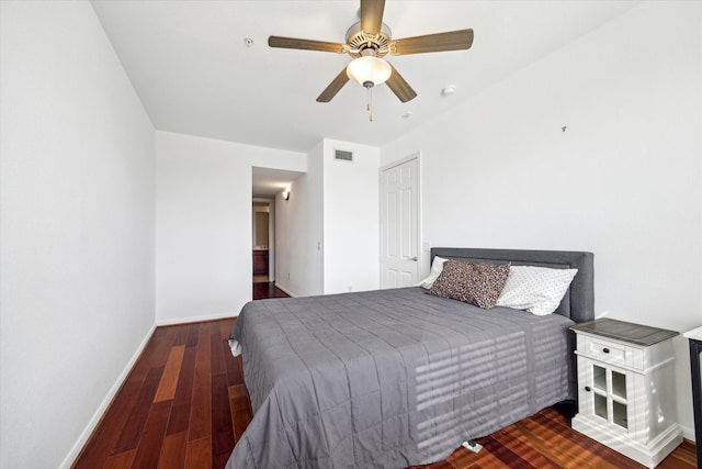 bedroom with ceiling fan and dark wood-type flooring