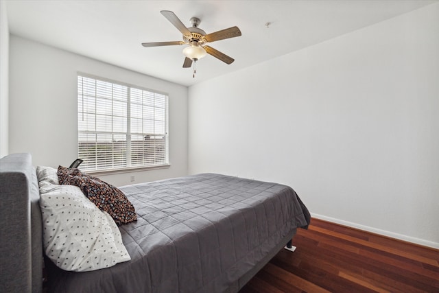 bedroom with ceiling fan and dark wood-type flooring