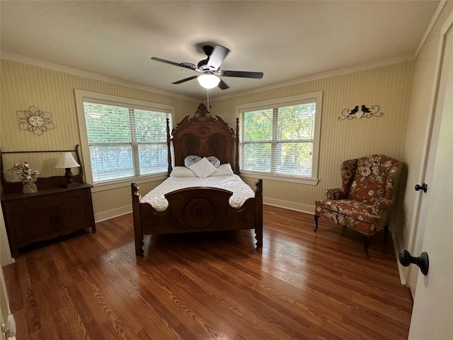 bedroom with dark wood-type flooring, ornamental molding, and ceiling fan