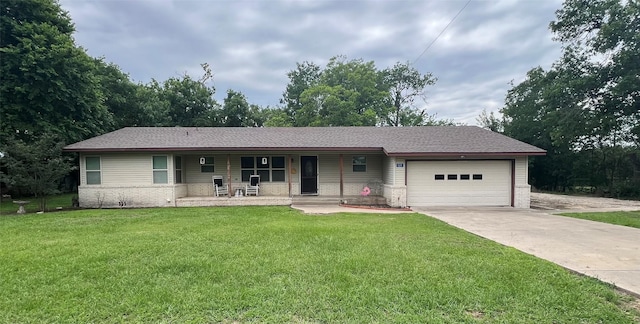 121 N Hauptstrasse St, Carmine, TX 78932 - ranch-style house featuring covered porch, an attached garage, concrete driveway, a front yard, and brick siding