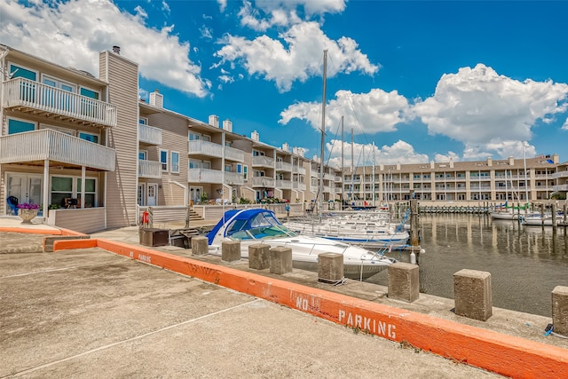 view of dock with a water view and a balcony