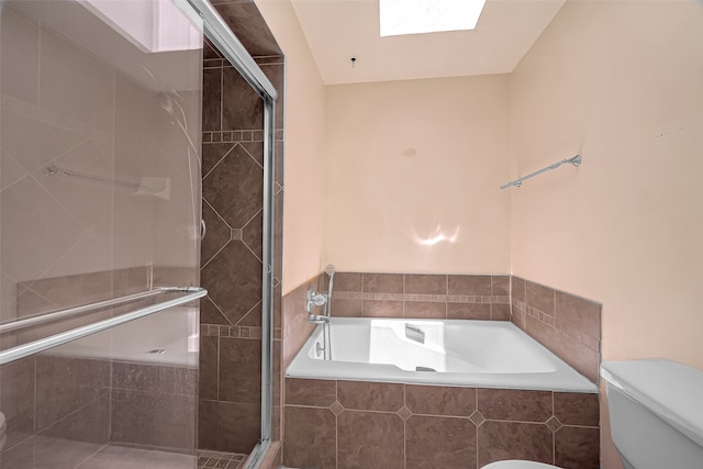 bathroom with a skylight, independent shower and bath, and toilet