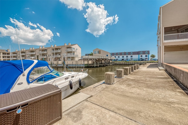 dock area featuring a balcony and a water view