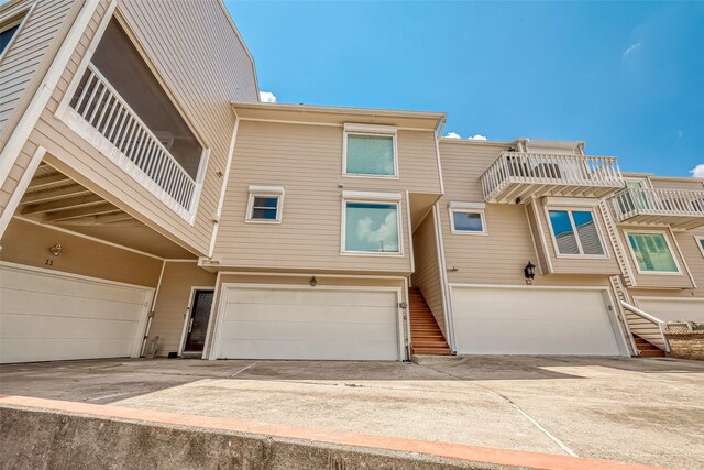 multi unit property with a balcony and a garage