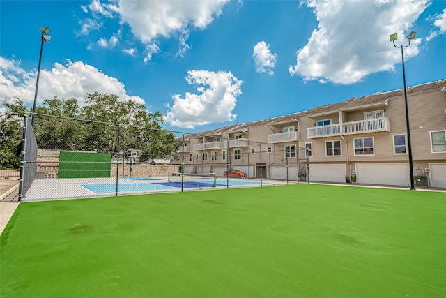 surrounding community featuring a garage and basketball hoop