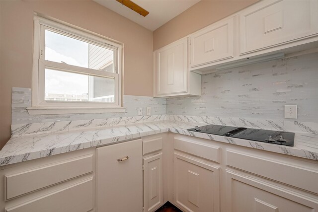 kitchen with white cabinetry and black electric cooktop