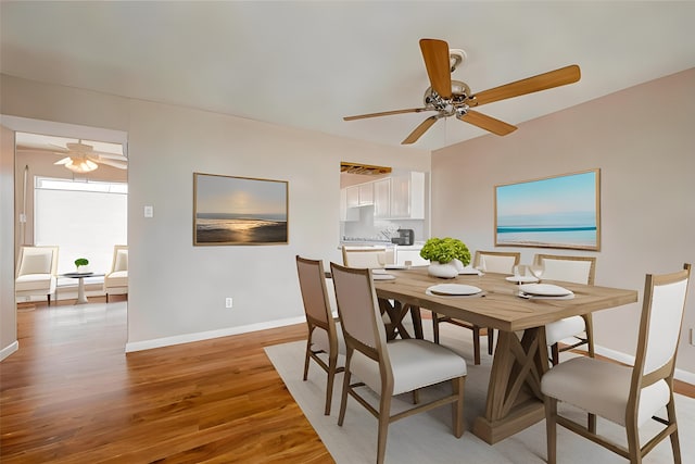 dining room with light wood-type flooring and ceiling fan