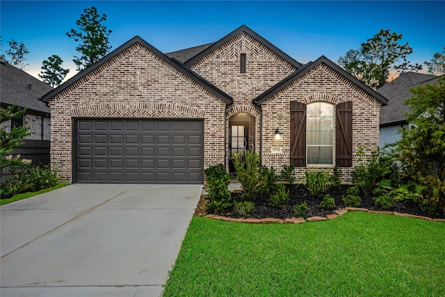 french country inspired facade with a front yard and a garage