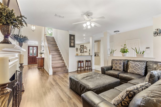 living room featuring ceiling fan and light hardwood / wood-style floors