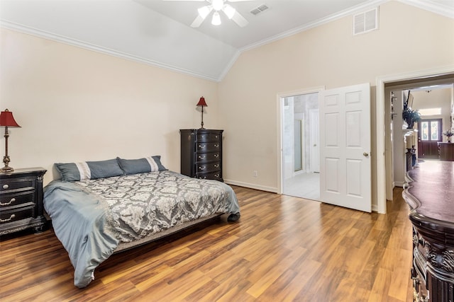 bedroom with hardwood / wood-style flooring, ceiling fan, lofted ceiling, and ornamental molding