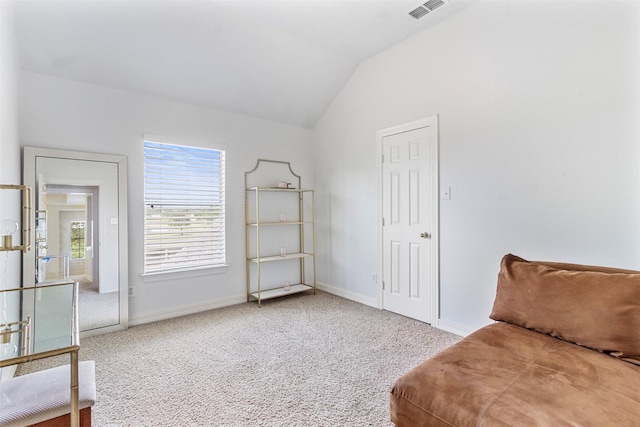 living area with carpet and lofted ceiling