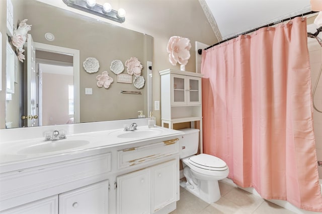 bathroom with a shower with shower curtain, vanity, vaulted ceiling, tile patterned flooring, and toilet