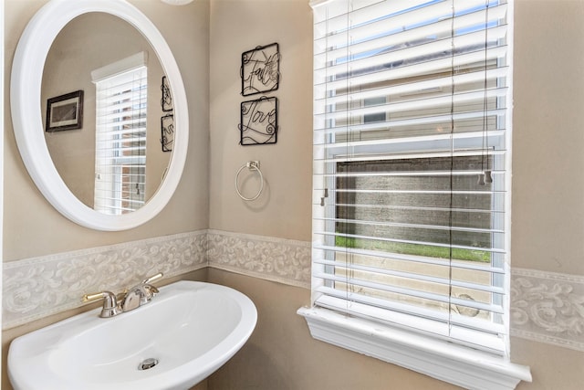 bathroom featuring a wealth of natural light and sink