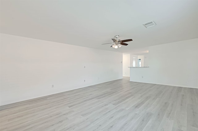 unfurnished room featuring light wood-type flooring and ceiling fan