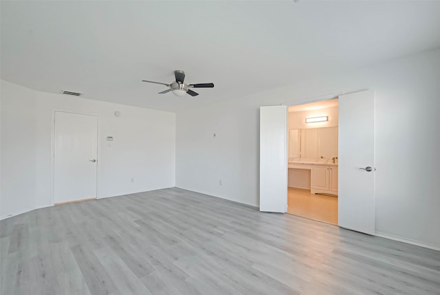 empty room with light hardwood / wood-style flooring and ceiling fan