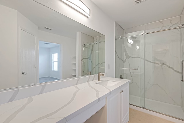 bathroom with vanity, tile patterned floors, and an enclosed shower