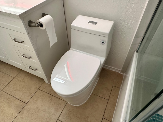 bathroom featuring tile patterned flooring and toilet