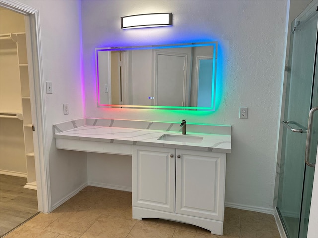 bathroom with a shower with door, vanity, and wood-type flooring