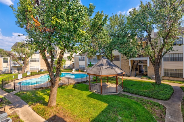 surrounding community featuring a pool, a gazebo, and a yard