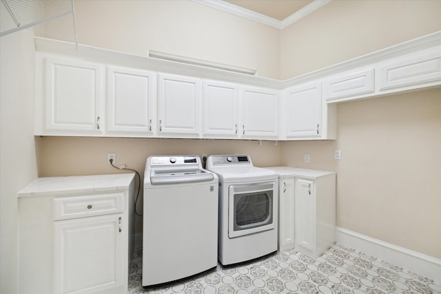 laundry area with cabinets, crown molding, and washer and dryer