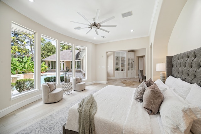 bedroom featuring light hardwood / wood-style floors, ceiling fan, and crown molding