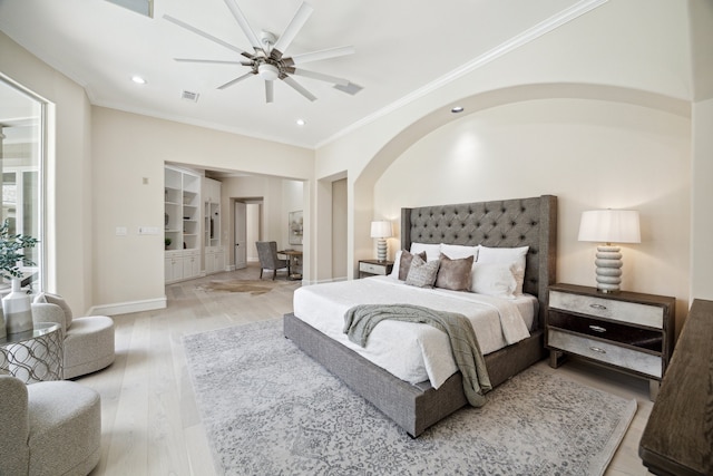 bedroom featuring ceiling fan, crown molding, and light hardwood / wood-style floors