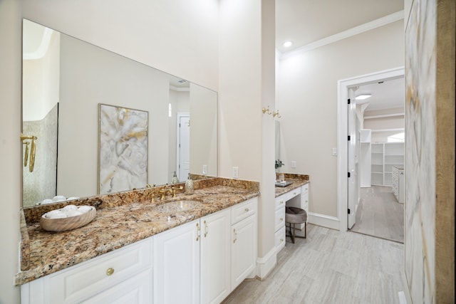 bathroom with ornamental molding and vanity