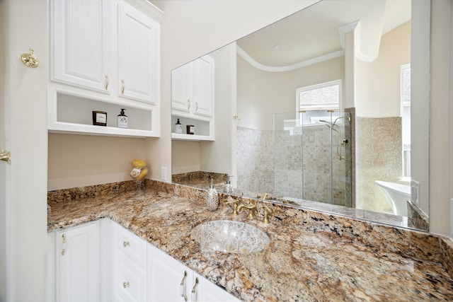 bathroom featuring ornamental molding, vanity, and an enclosed shower