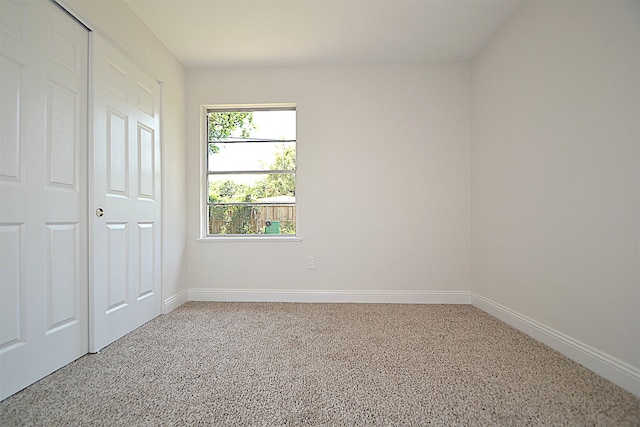 unfurnished bedroom with a closet and carpet floors