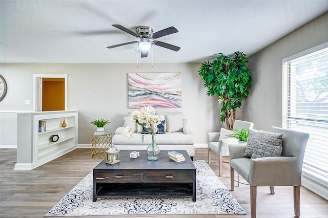 living room featuring light wood-type flooring and ceiling fan