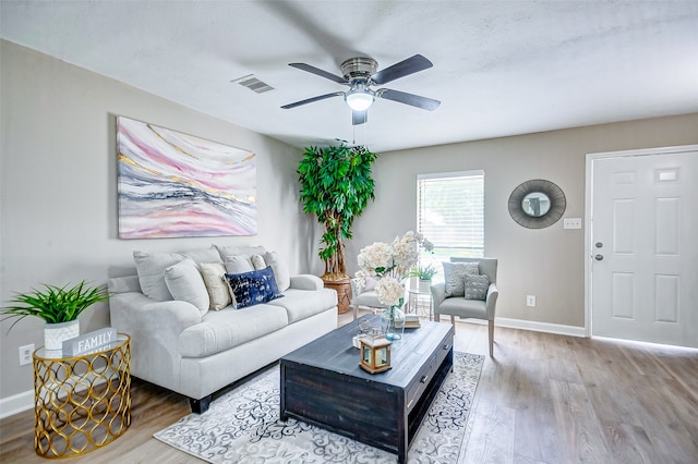 living room featuring ceiling fan and hardwood / wood-style floors