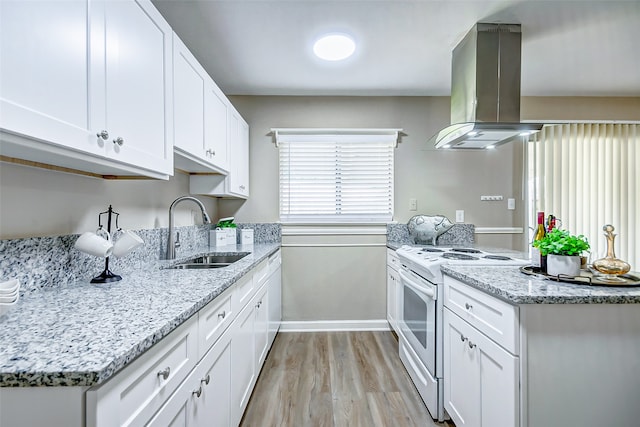 kitchen with white cabinets, white gas range oven, light wood-type flooring, island range hood, and sink